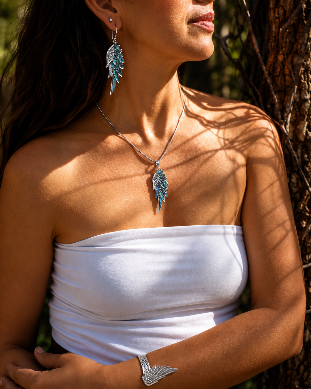 Silver Spirit Wing jewellery in sunlit woodland